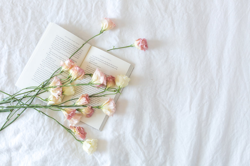 bed-with-book-and-flowers